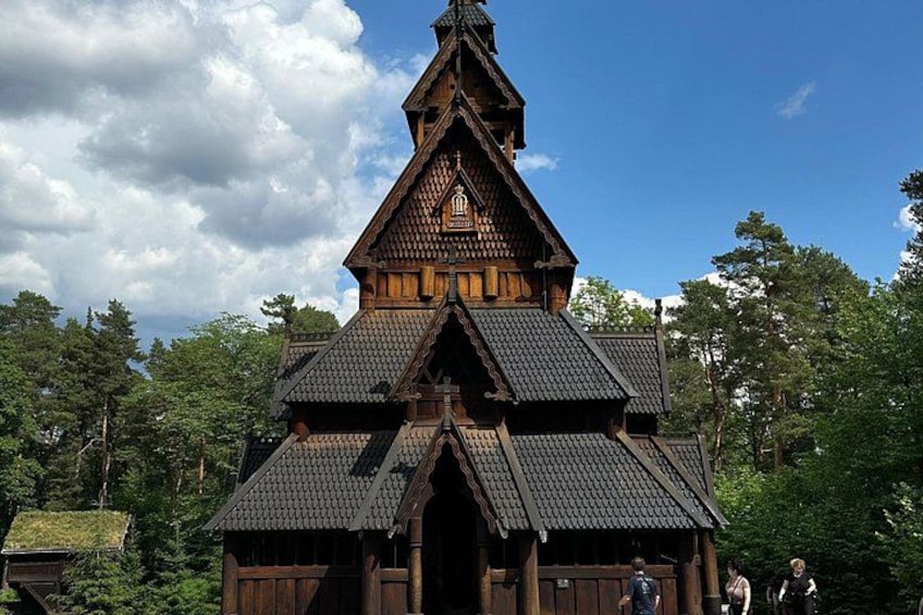 A wooden building with a steeply pitched roof and a bell tower. 2