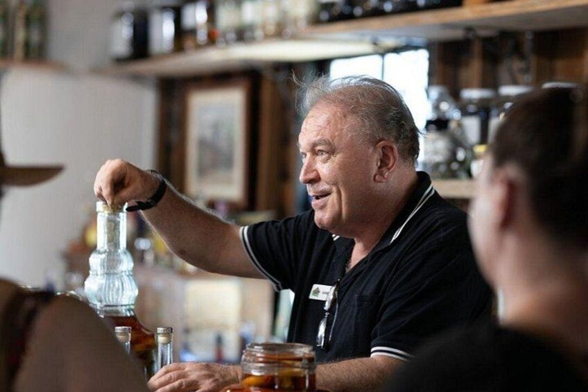A person pouring a drink from a bottle into a glass. 3