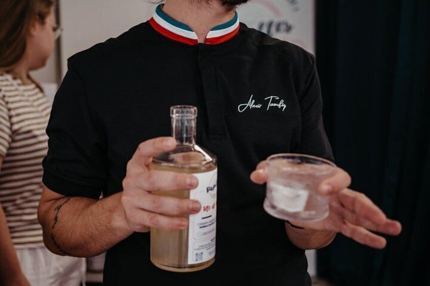 A person holding a bottle and a glass. 2