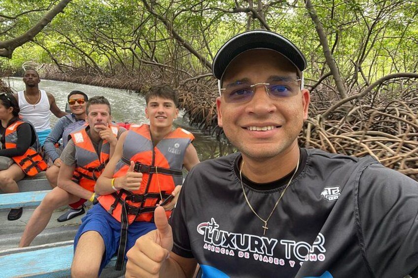 A group of people on a boat in a mangrove area. 3