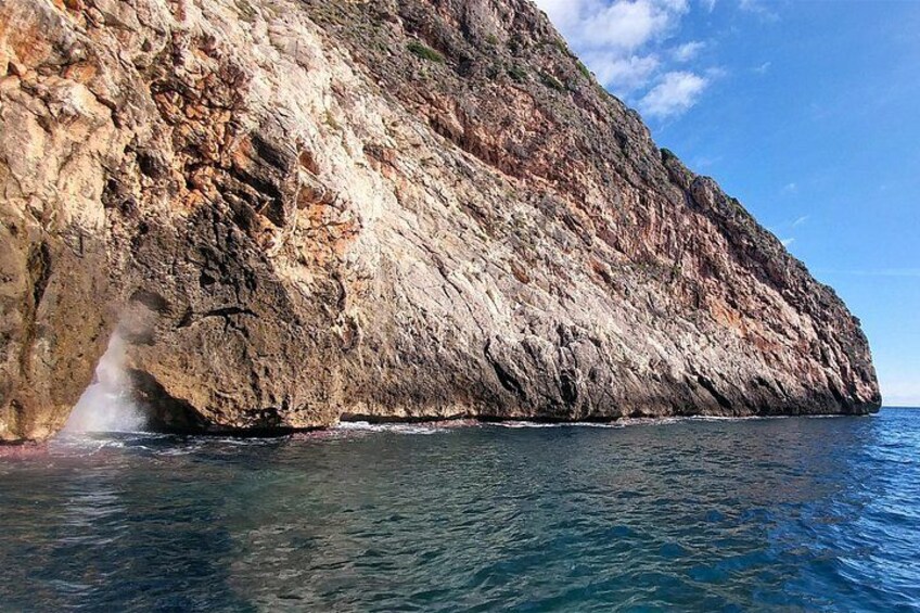 A rocky coastline with a clear blue sky. 4