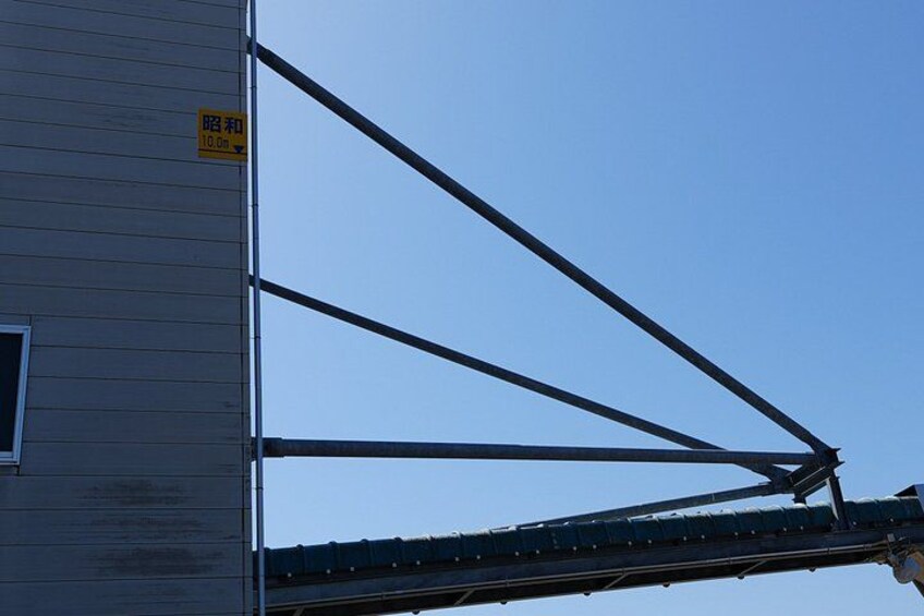 A building with a metal structure extending from its side. 5