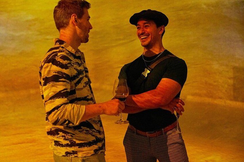 Two people shaking hands and holding a glass of wine. 1
