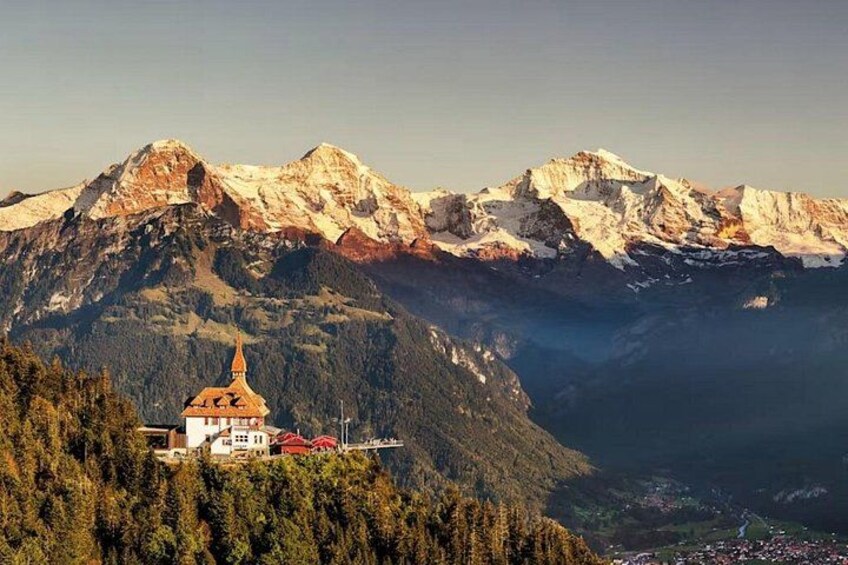 A mountain landscape with a church and snow-capped peaks. 4