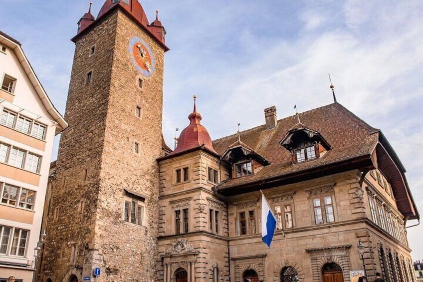 A historic building with a clock tower and a red dome. 4