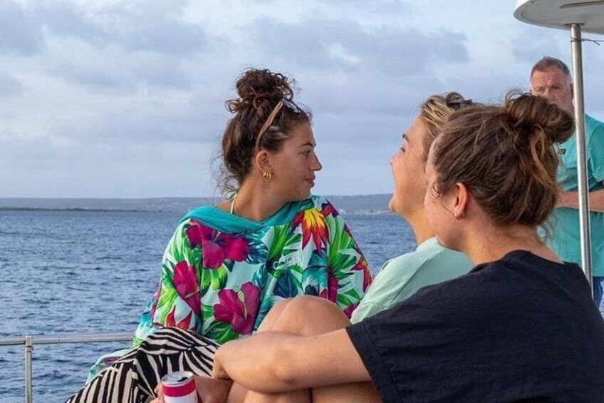 People on a boat with a view of the ocean. 4
