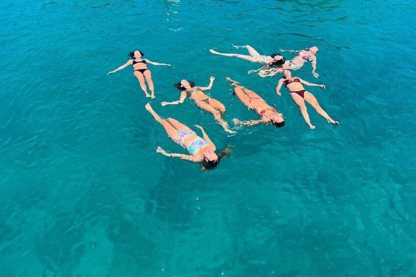 People floating in clear blue water. 3