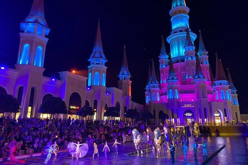 A castle-like building with multiple towers and a crowd of people in front. 3
