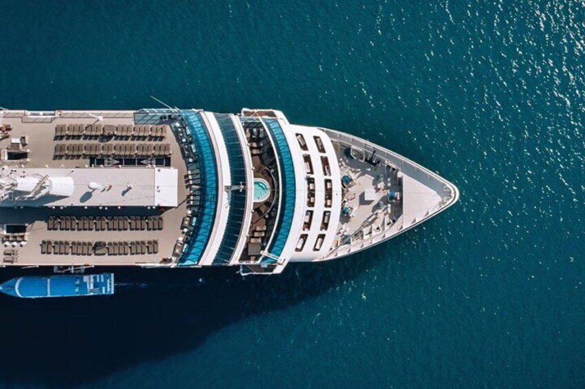 A large cruise ship with multiple decks and a swimming pool. 2