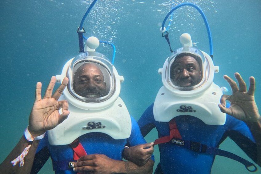 Two people underwater wearing scuba diving gear. 2