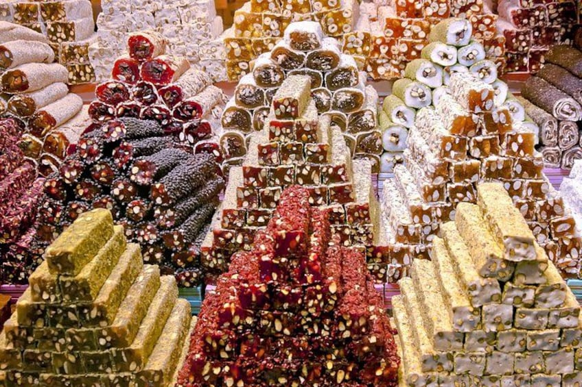 A variety of colorful and intricately decorated sweets displayed in a market. 3