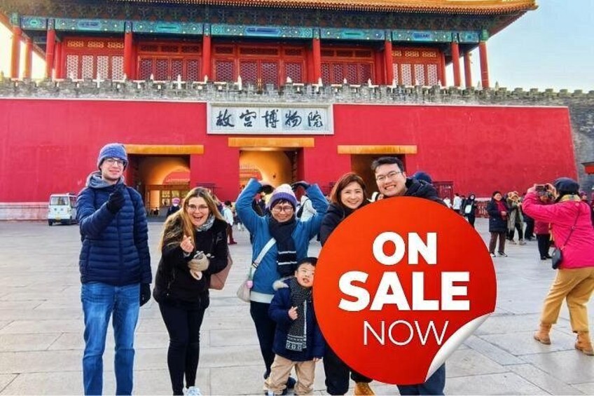A group of people in front of a red building with traditional architecture. 1