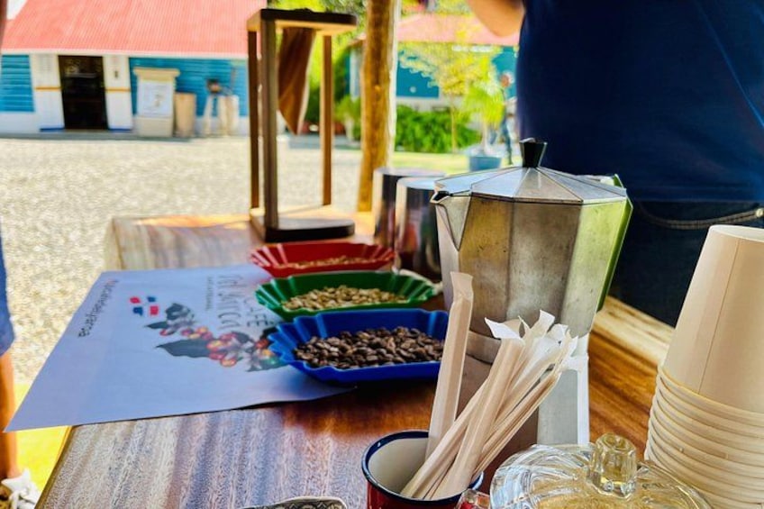 A table with coffee beans, a coffee grinder, and a menu. 3