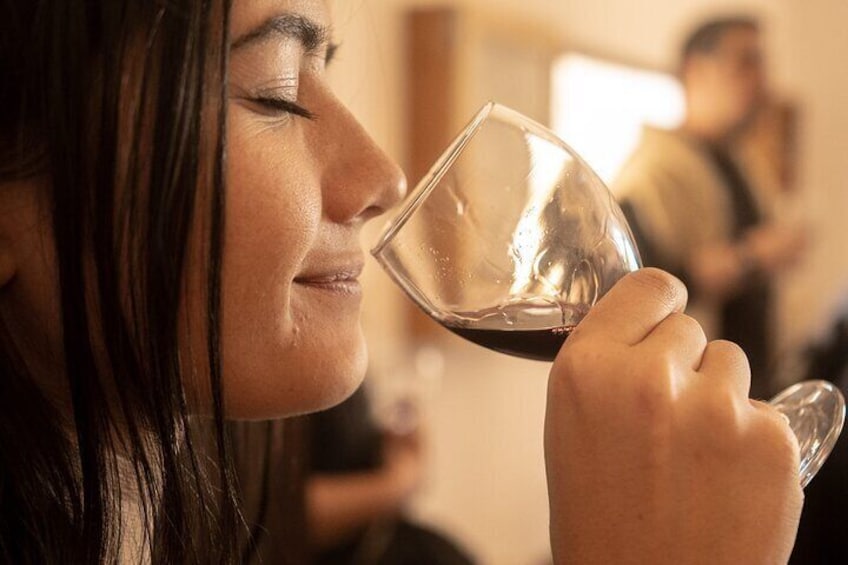 A person holding a wine glass. 5