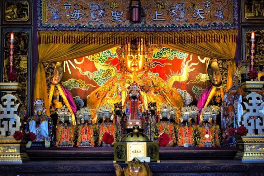 A temple altar with intricate decorations and statues. 2