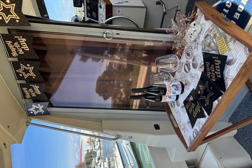 A table with a glass top, star decorations, and a bottle. 5