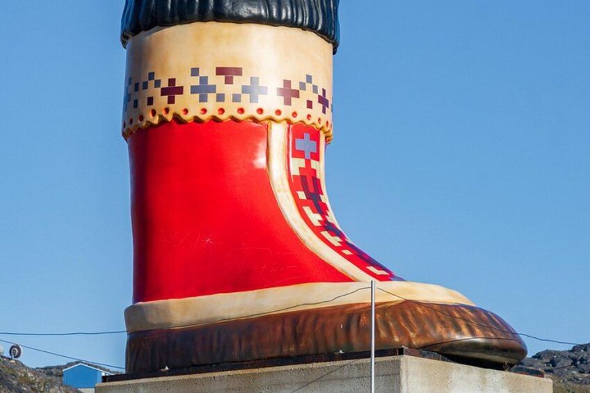 A large, red and brown sculpture resembling a giant boot. 2