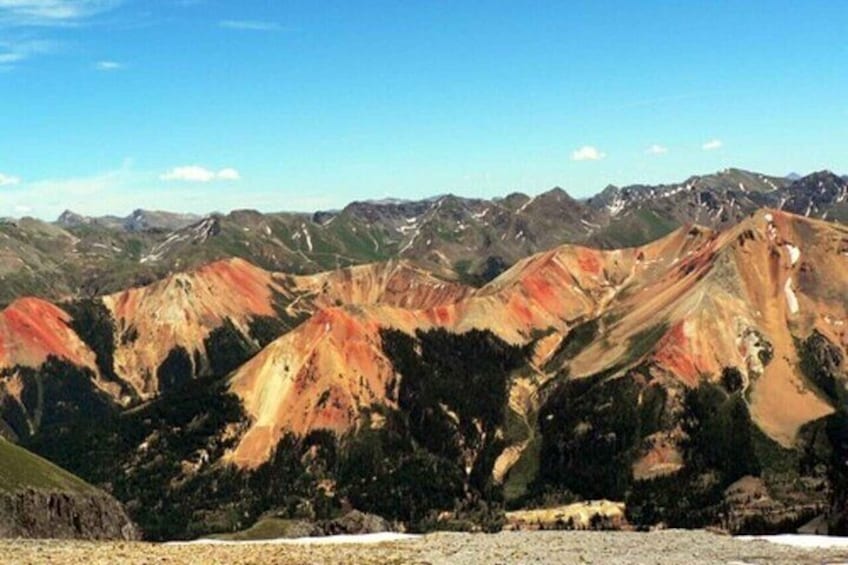 A mountainous landscape with distinct red and green hues. 3