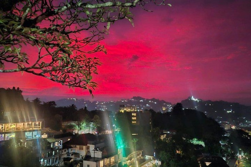 A cityscape at night with a vibrant red sky. 5