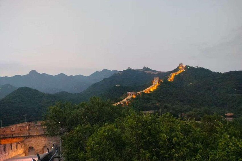 The Great Wall of China winding through a mountainous landscape at dusk. 3