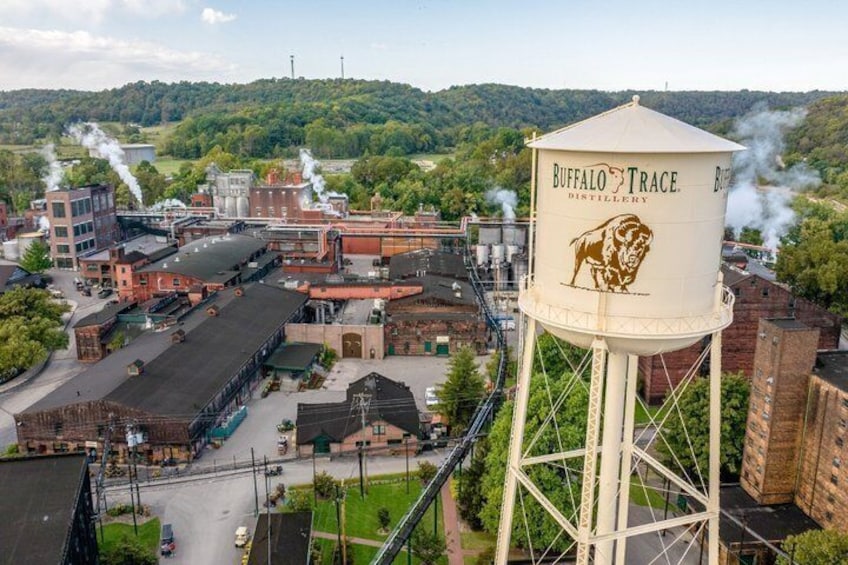 A water tower with 'Buffalo Trace Distillery' branding, surrounded by industrial buildings and a hilly landscape. 3