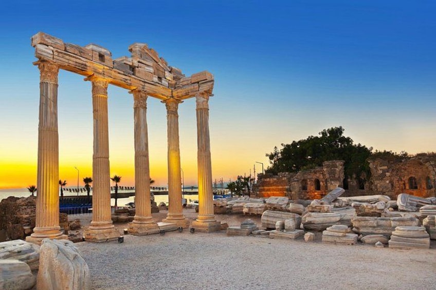 Ancient ruins with columns and scattered stone blocks. 1