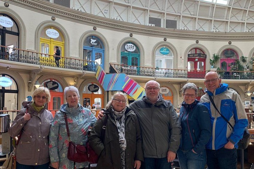 A group of people in a shopping mall with multiple levels and shops. 2