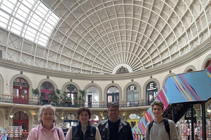 A large indoor shopping mall with a high arched ceiling and multiple levels. 3