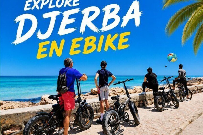 People on bicycles by a beach with clear skies. 1