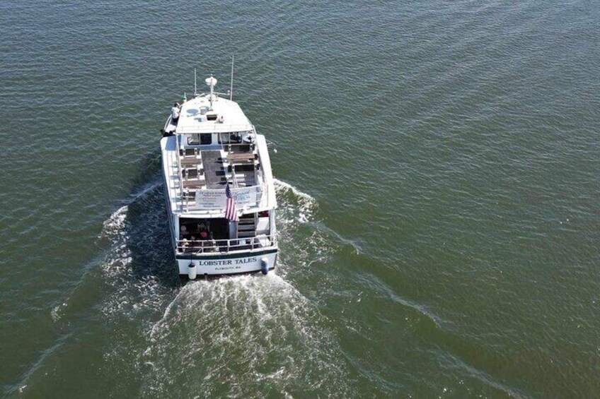 A white boat named 'Lobster Tales' on water. 3