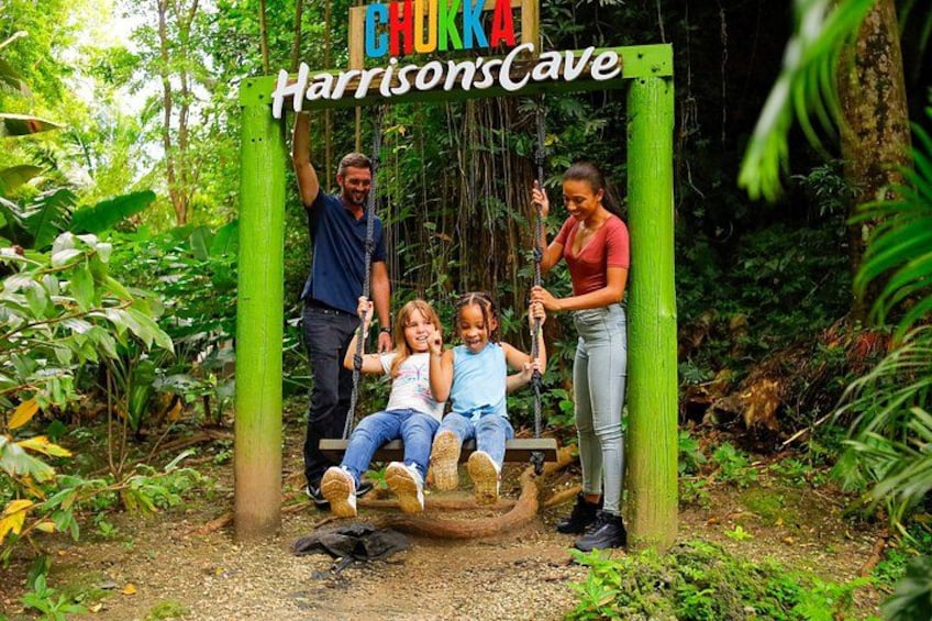 A swing set labeled 'CHUKKA HarrisonsCave' in a forested area. 4