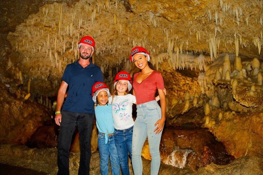 A family in a cave with stalactites. 5