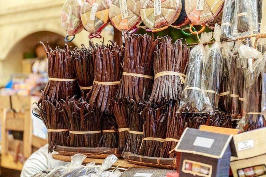 Bundles of dried vanilla pods and other dried goods for sale. 2