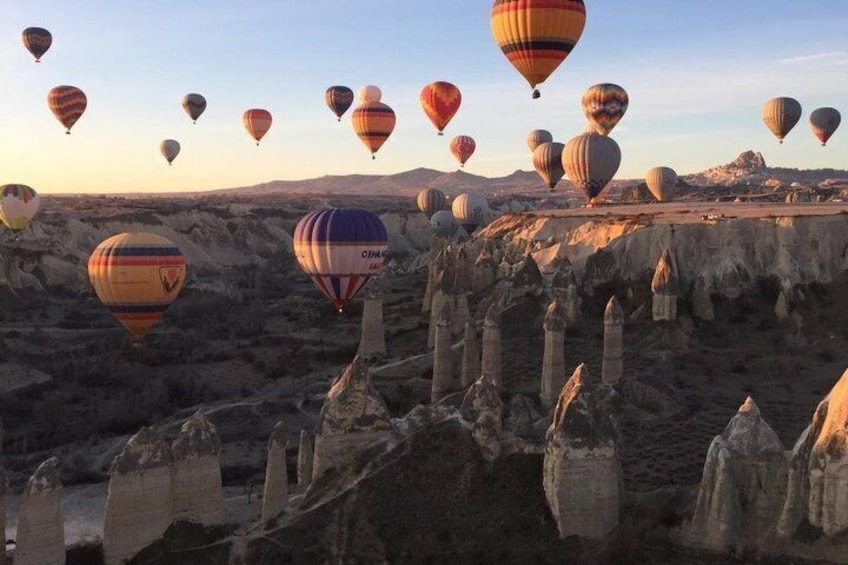 Hot air balloons over a rocky landscape with unique rock formations. 4