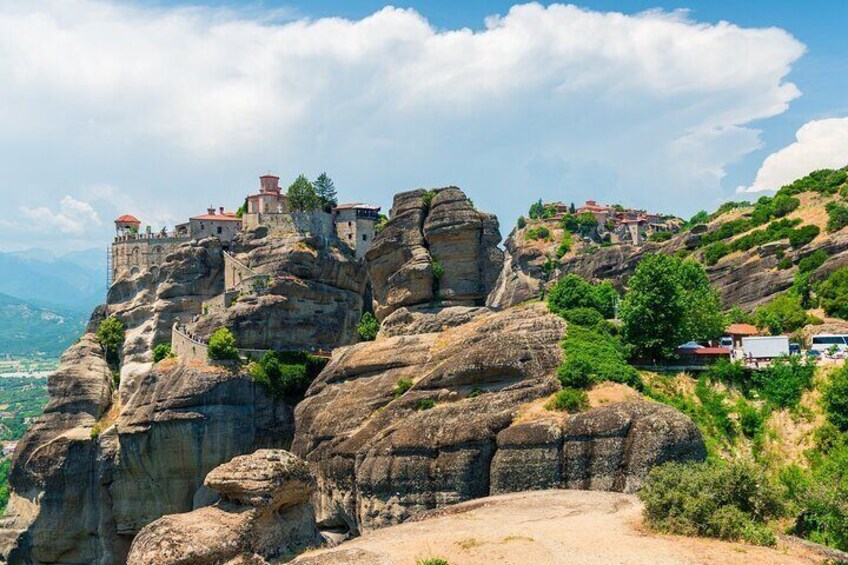 A monastery on a rocky hill with a clear sky. 1