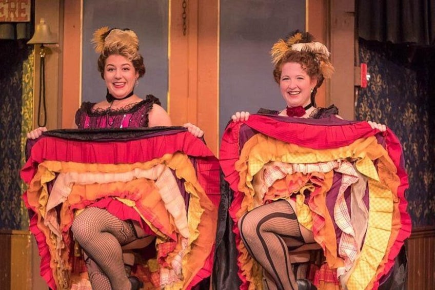 Two individuals holding large, colorful fabric pieces. 1