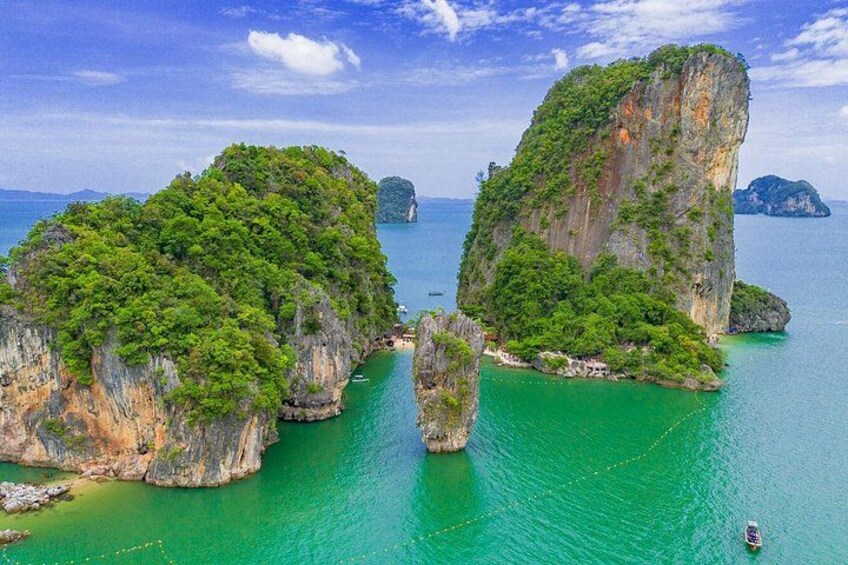 A coastal landscape with two prominent limestone islands surrounded by turquoise waters. 1