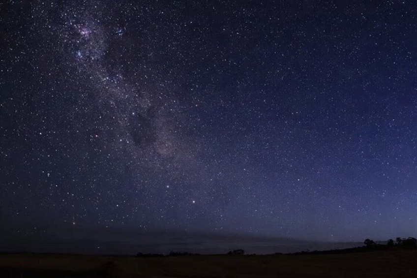 A starry night sky over a flat landscape. 2