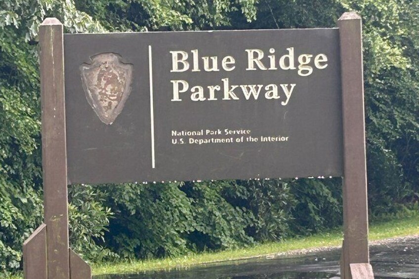 A sign for Blue Ridge Parkway with the National Park Service emblem. 3