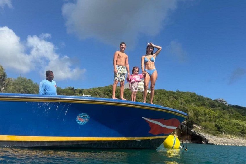 A family on a boat with a tropical landscape in the background. 2