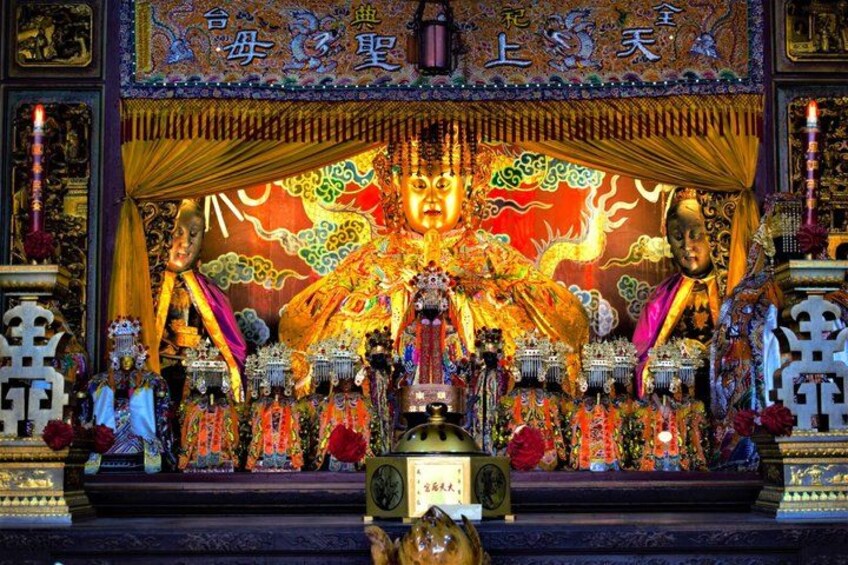 A temple altar with intricate decorations and statues. 3