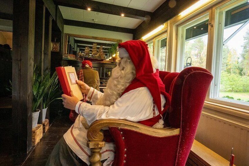 A person in a red chair reading a book. 3