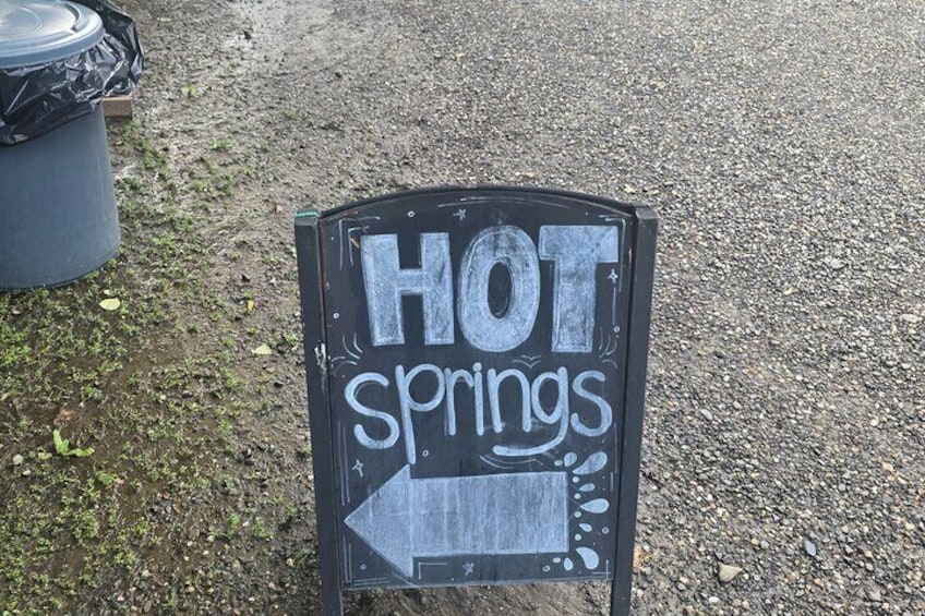 Ein Schild mit der Aufschrift "HOT springs" und einem nach links zeigenden Pfeil. 1