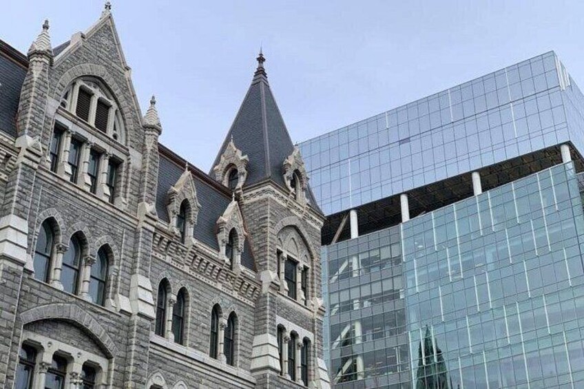A historic building with ornate architecture and a modern glass skyscraper. 2