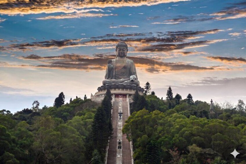 A large Buddha statue on a hill with a clear sky. 1