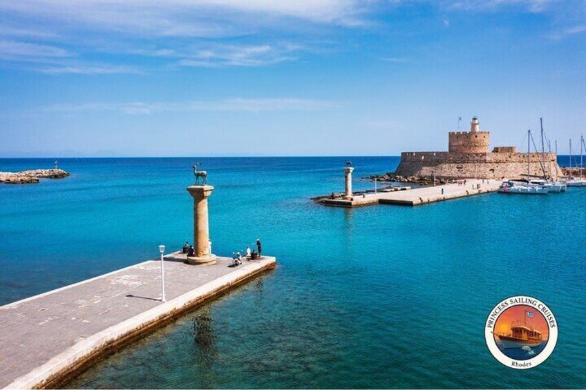 A coastal fortification with a lighthouse, calm sea, and clear sky. 4