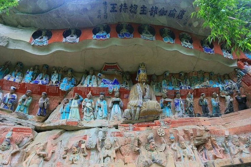 A large rock formation with numerous statues of deities and monks. 2