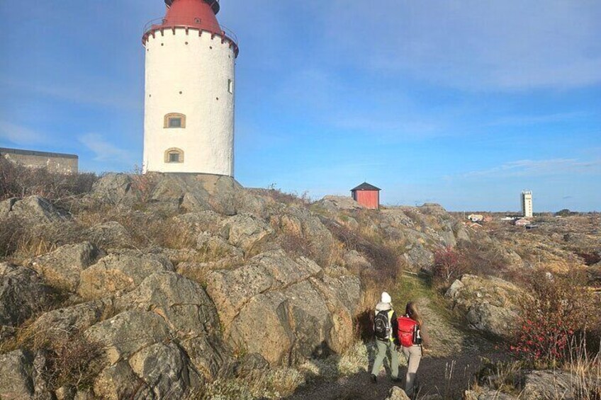 A rocky landscape with a lighthouse and a small red building. 5