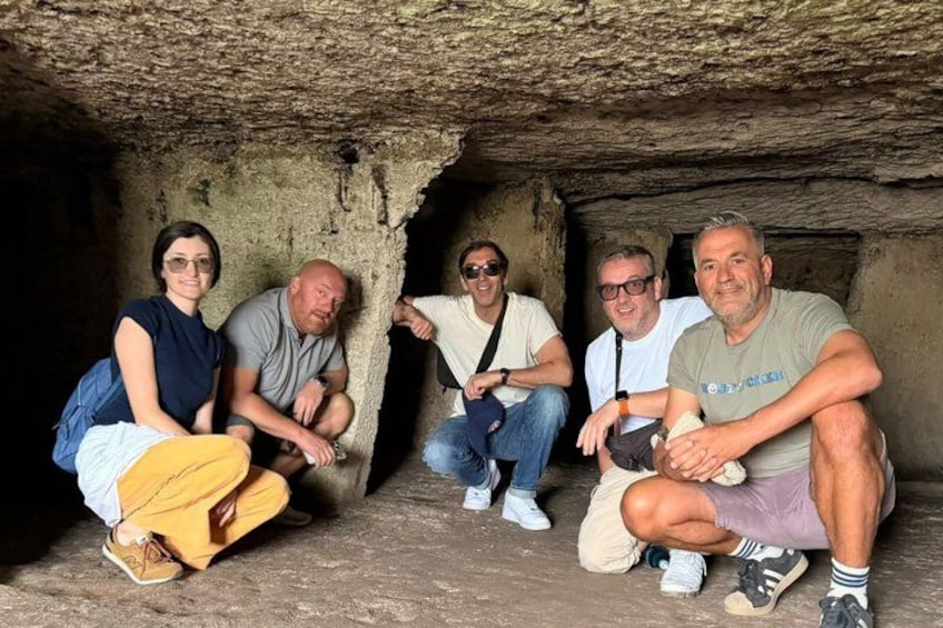 A group of people sitting in a cave. 3