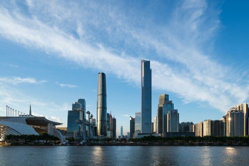 A city skyline with modern skyscrapers and a river in the foreground. 5